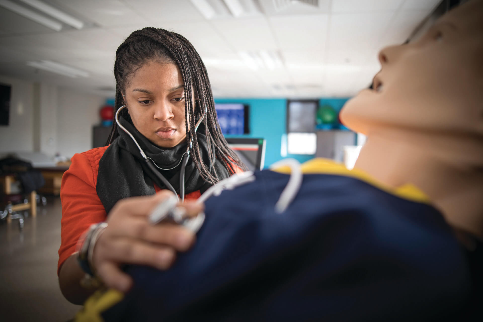 Student practicing taking heart beat