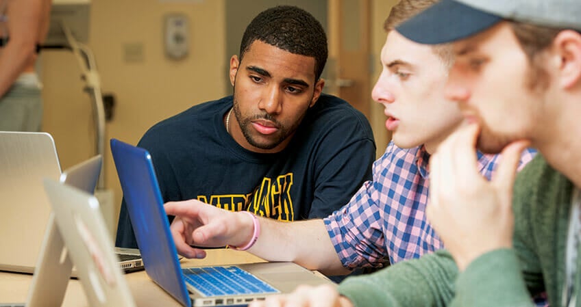 students looking at computer.