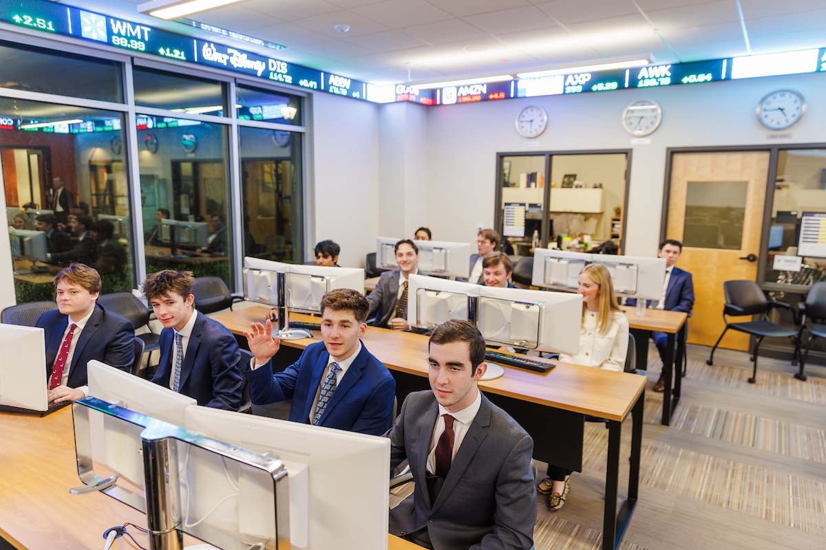 Students dressed in suits sitting in the Mucci Lab