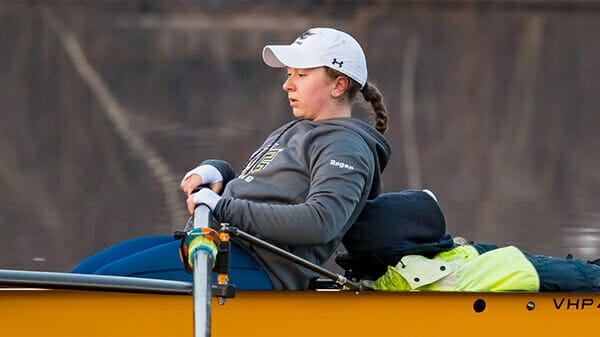 Student-athlete rowing in the water.
