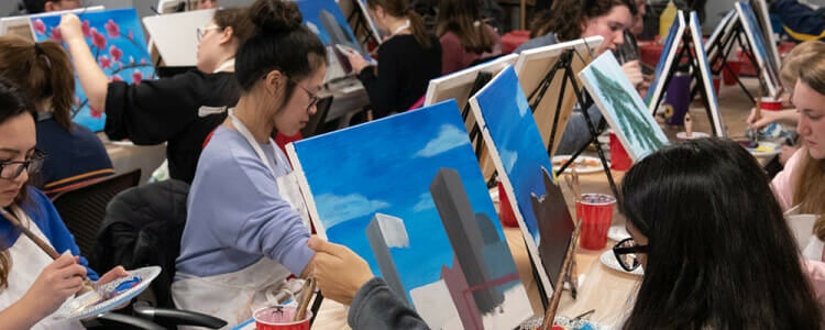 Students participating in a painting activity