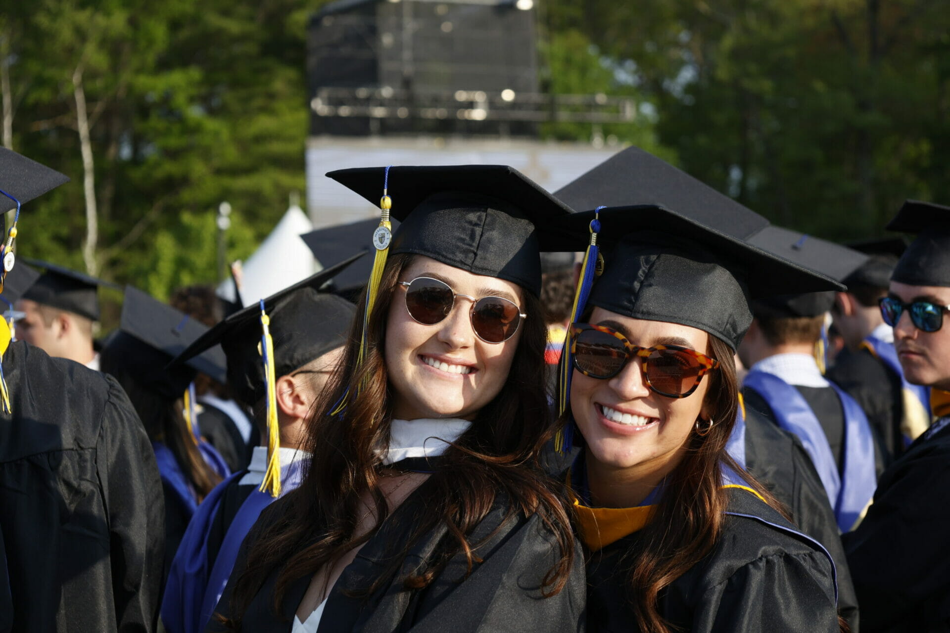 Photo of two smiling graduates at the Merrimack College 73rd Commencement exercises.