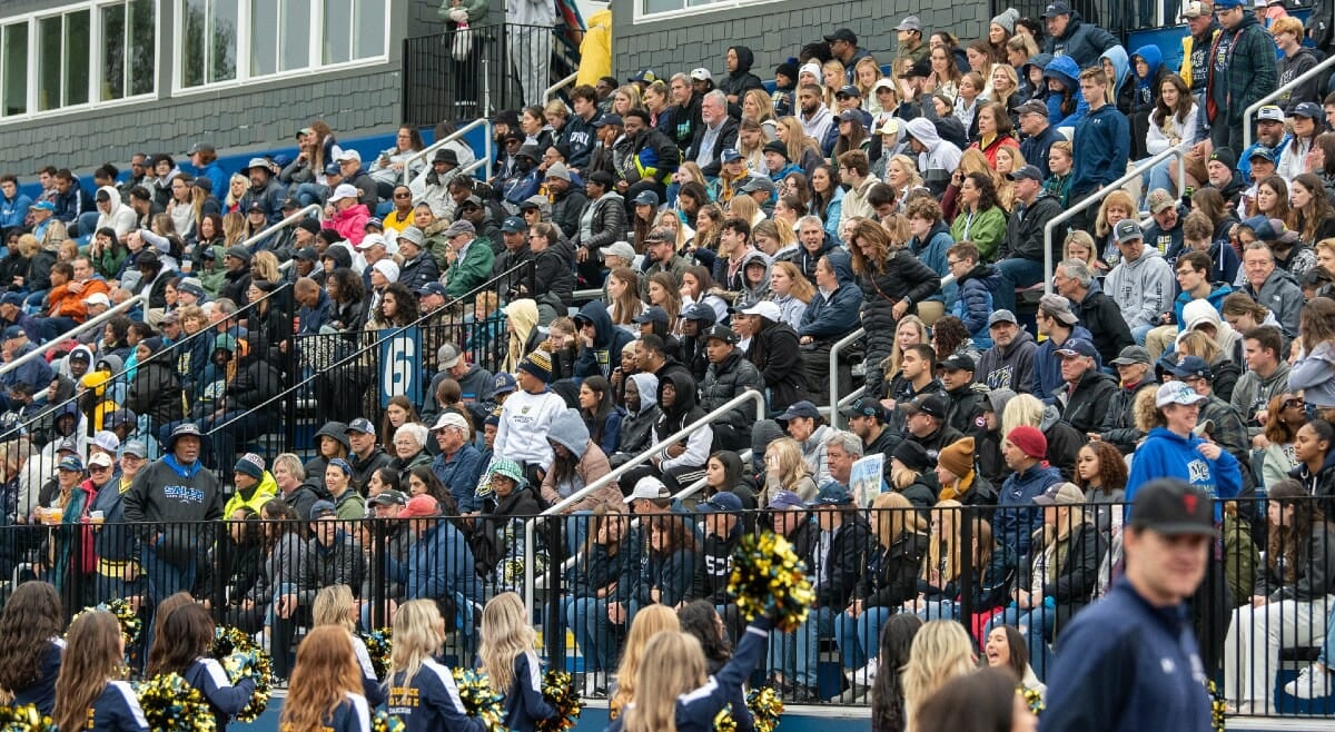 Crowded stands at a Merrimack homecoming football game.