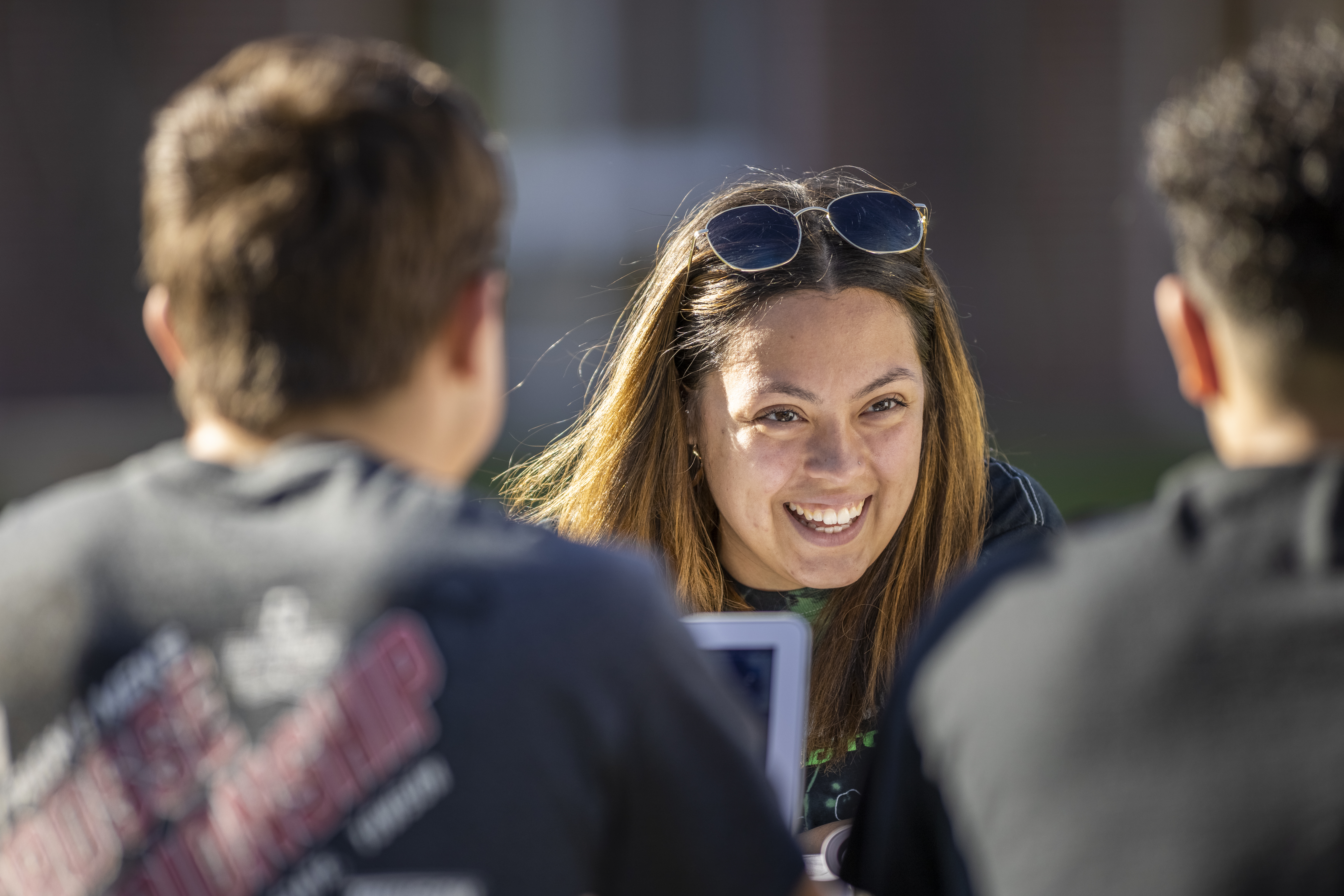 Students sitting together around laptops