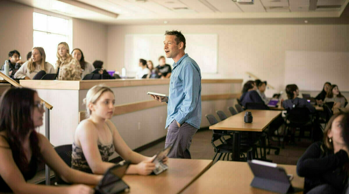 Photo of a Merrimack professor teaching a class.
