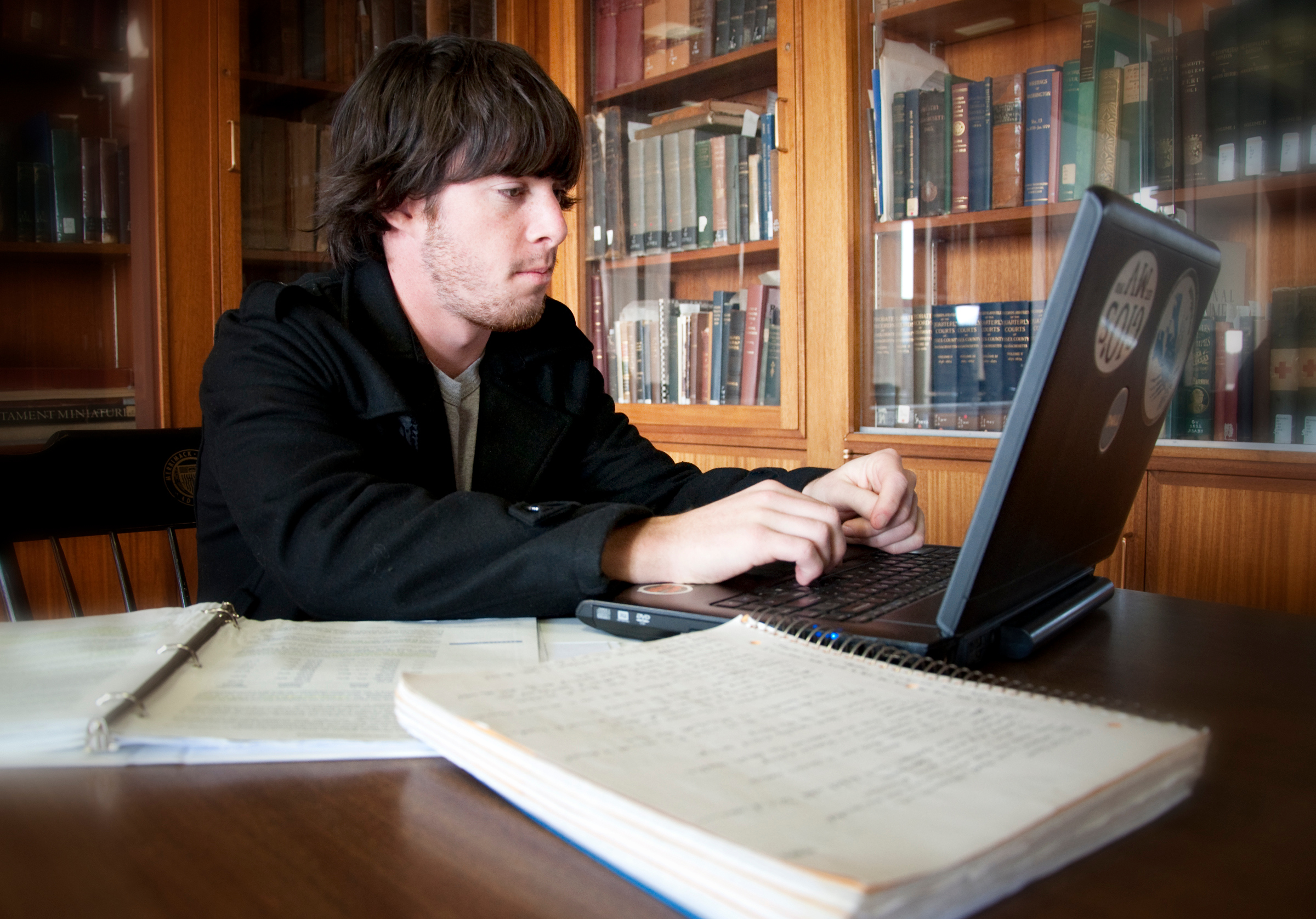 Student working on laptop in library