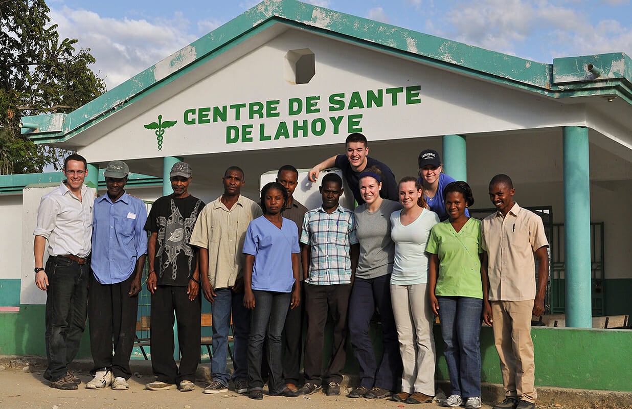 Merrimack students standing in front of the Centre de Sante de La Hoye in Haiti