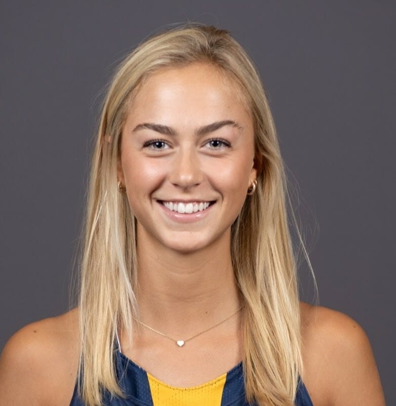 Emma Bouvier, smiling student in Merrimack College sleeveless jersey.