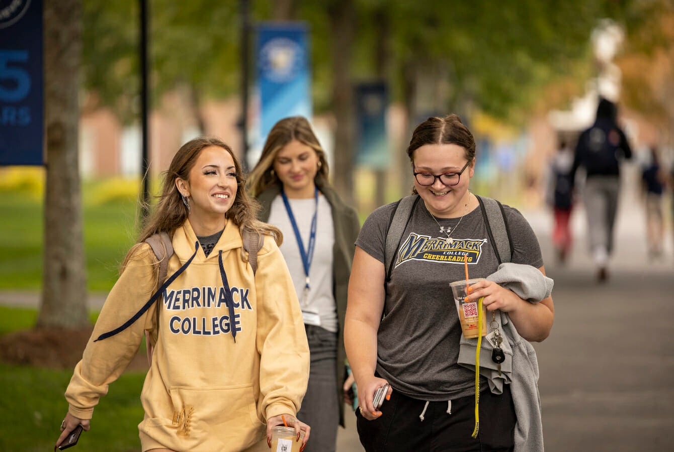 Group of cheerful students walking on campus