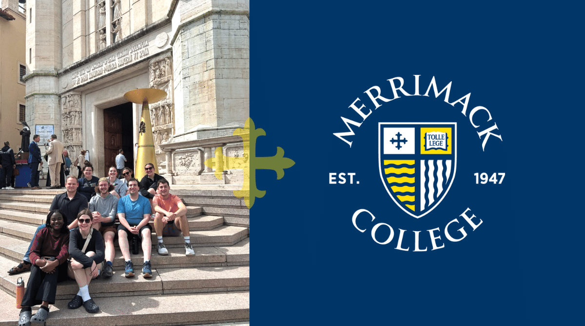 A group of students smiling while sitting on church steps in front of ornate carvings.