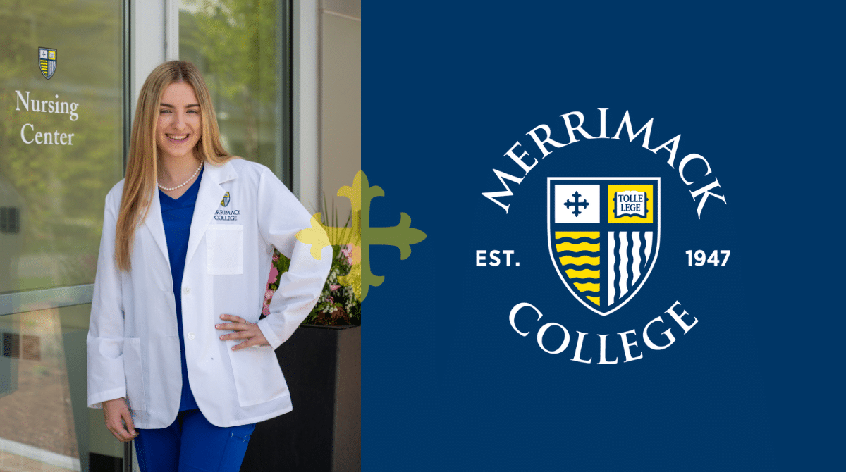 Smiling nursing student in white coat and blue scrubs outside Merrimack College Nursing Center entrance.