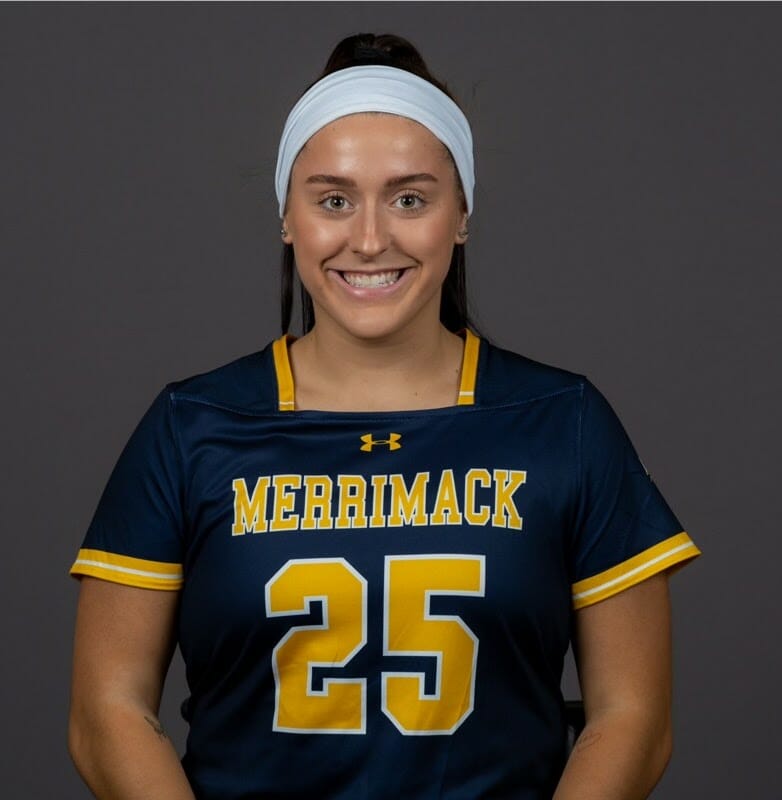 Kelly Corrigan, a student with a headband in a Merrimack College jersey with the number 25 on it.