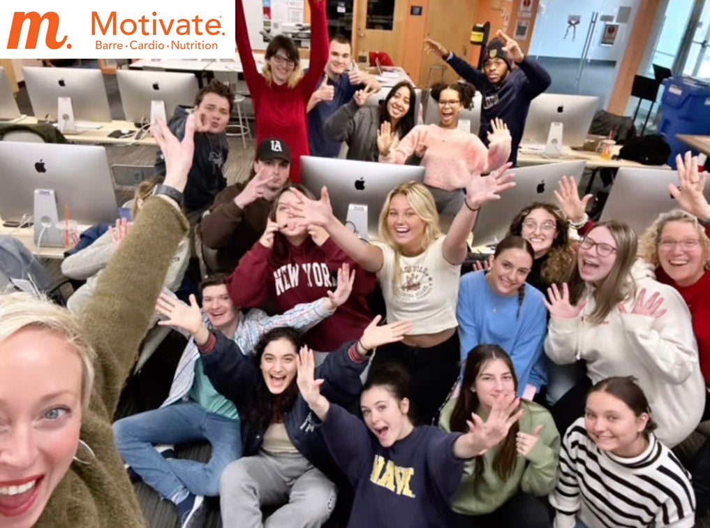 Motivate Owner Meghan Kinsey with posing graphic design students