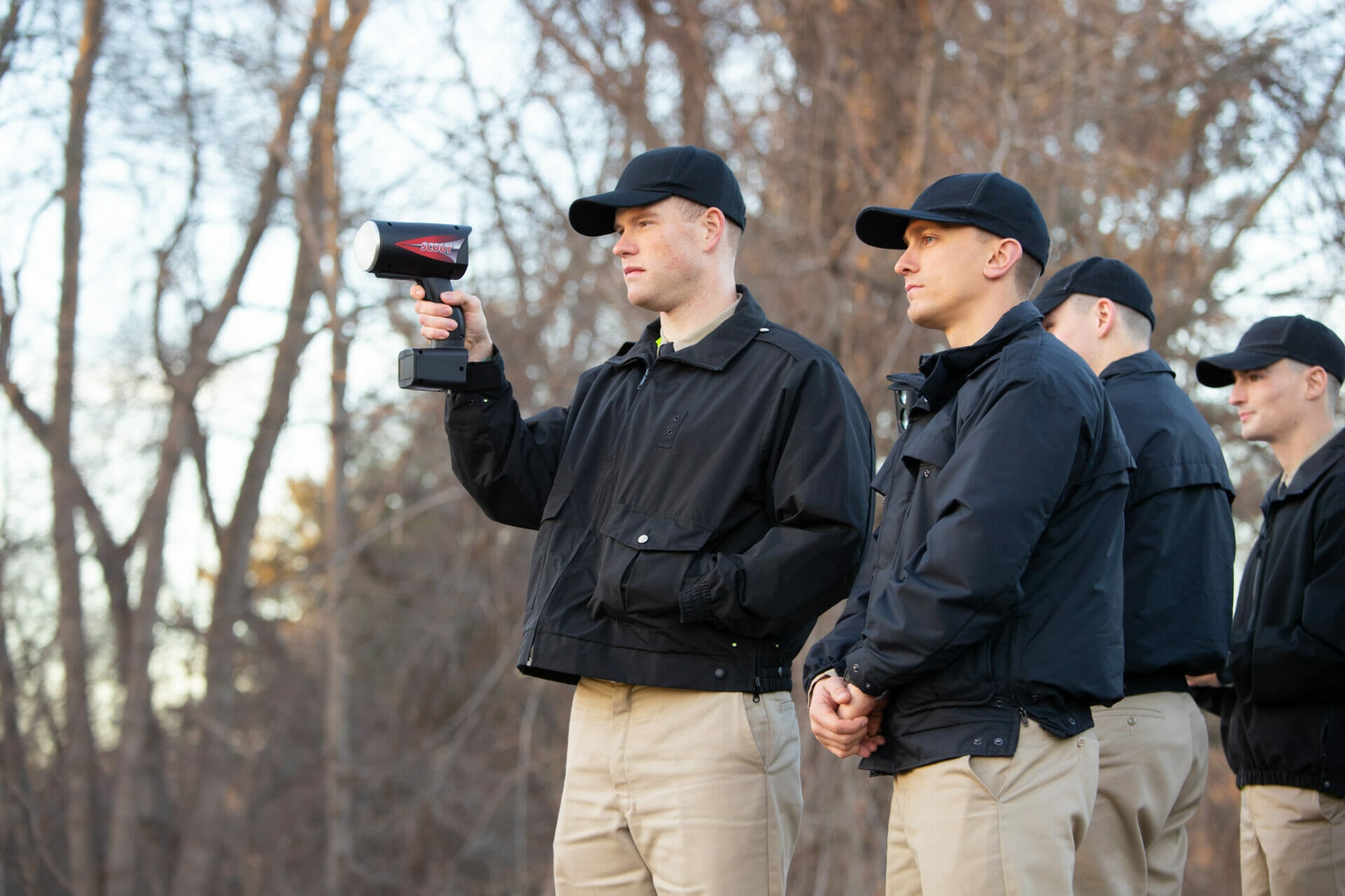 Police academy participants holding a speed gun