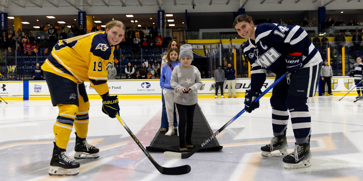Female hockey players at a ceremonial faceoff