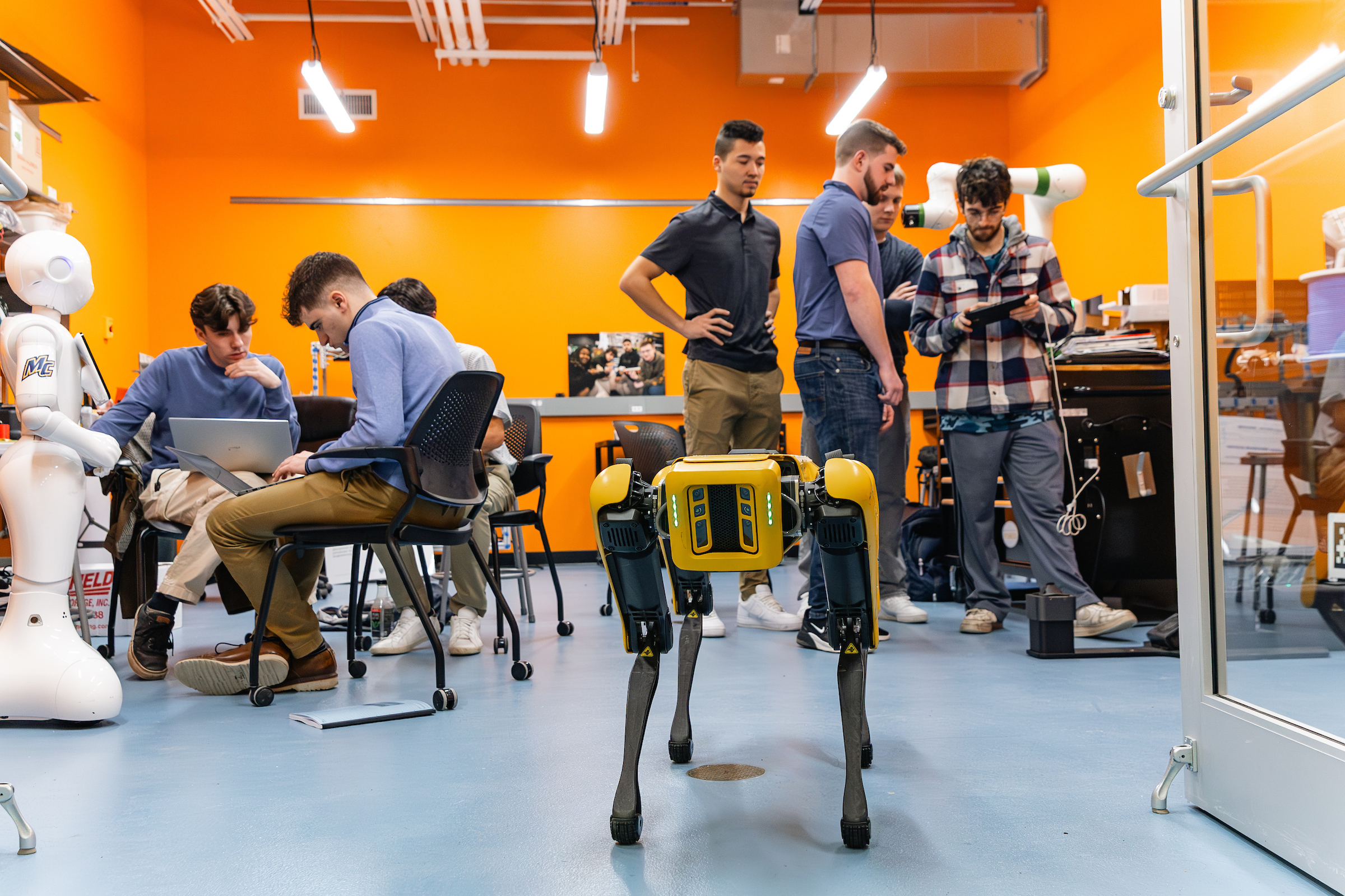 Engineering classroom with robots and students