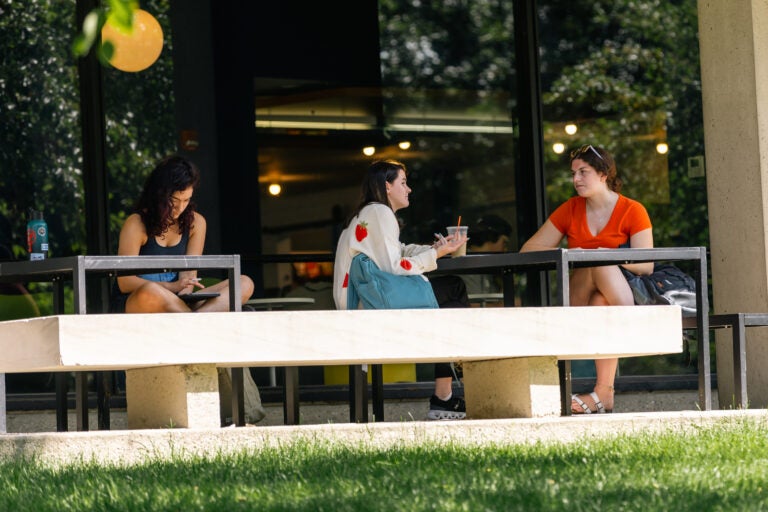 Students sitting outside of McQuade Library