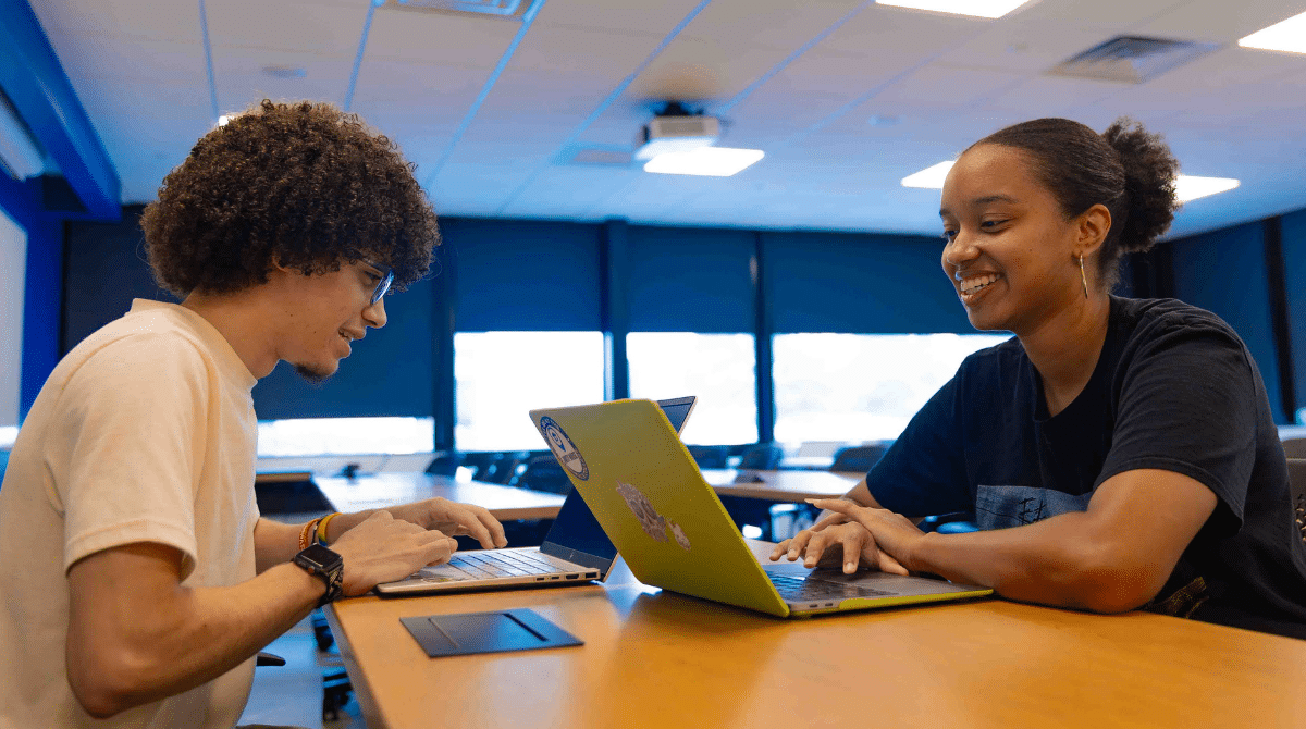 Two students working on their laptop