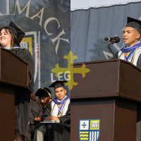 Photo of Jessica Almeida M’23 and Michael Fernandez ’23 speaking at Merrimack College’s 73rd Commencement exercises.