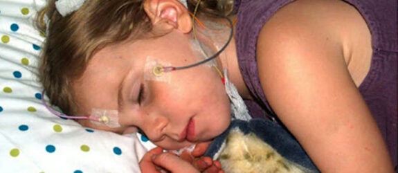 Child sleeping with sensors placed on the head as part of the research lab.
