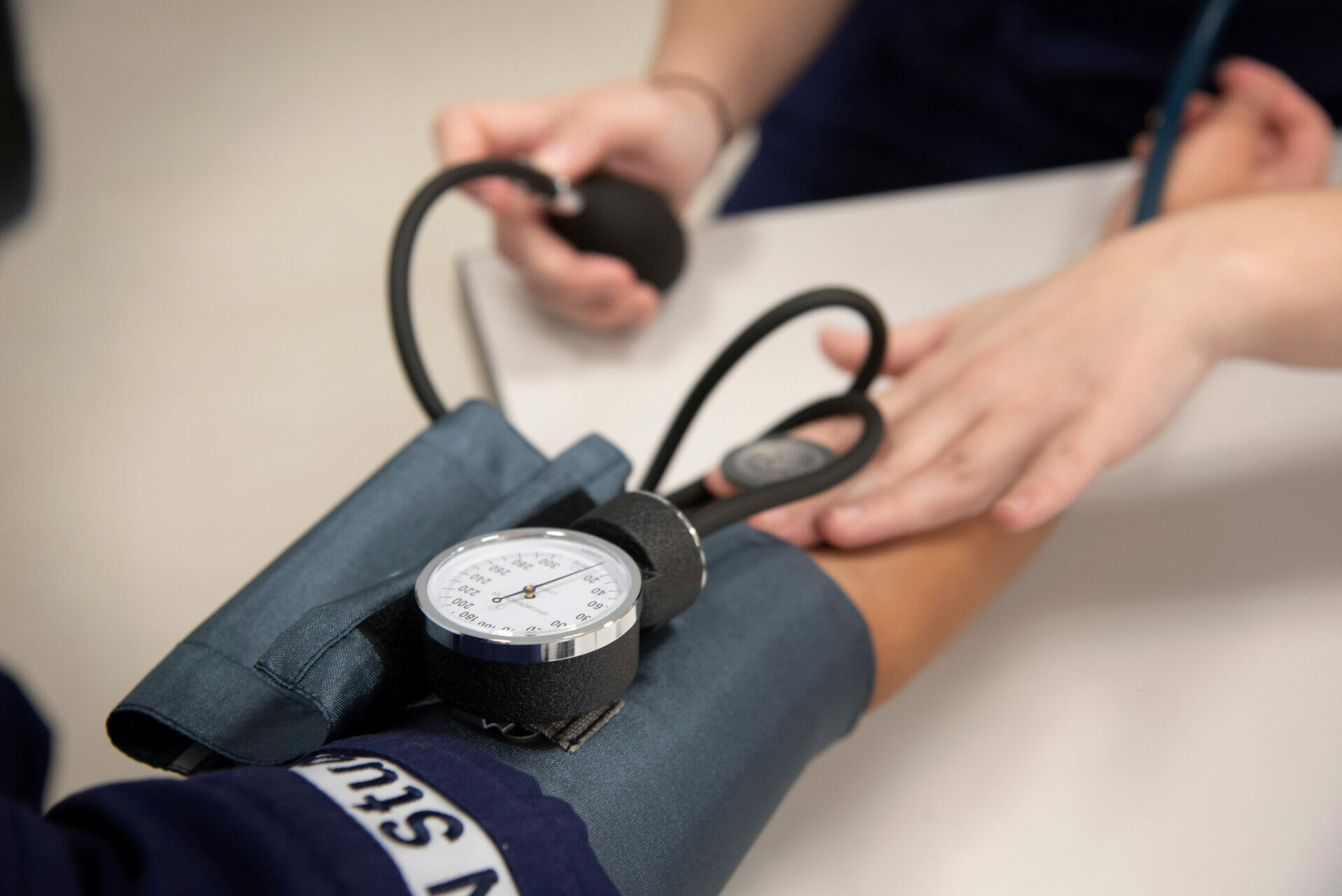 Student practicing taking vitals