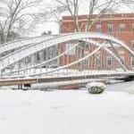Snow on Merrimack College's steel bridge